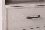 The drawer of the Sennori nightstand: a slim dark bronze bar pull on cerused oak with a narrow stepped border