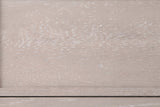 Close-up of the cerused oak on the Sennori nightstand: pale greige wood with white-filled grain and the narrow stepped drawer border
