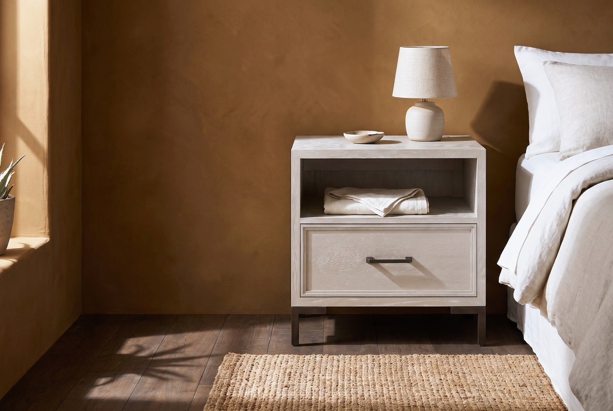 Sennori cerused oak nightstand with an open shelf and a bronze bar pull beside a bed in a Santa Fe bedroom with an ochre clay plaster wall