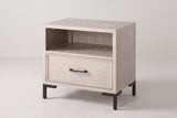 The Sennori nightstand in pale cerused oak with an open shelf, one drawer and dark bronze legs, three-quarter view on a light studio backdrop