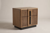 The Senorbi two-drawer nightstand in ash brown with reeded drawer fronts and black vertical pulls, three-quarter view on a light studio backdrop