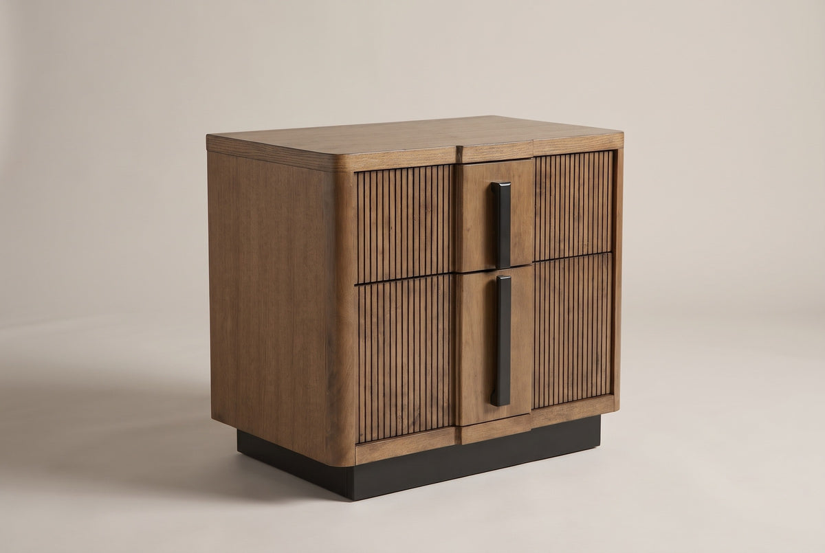 The Senorbi two-drawer nightstand in ash brown with reeded drawer fronts and black vertical pulls, three-quarter view on a light studio backdrop
