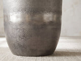 Close-up of the Sepino Antique Silver Metal Drum Side Table: the burnished band and the curve down to the foot
