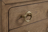 The upper drawer of the Serramanna nightstand: an antique-brass ring pull on a slim post beside the rounded drawer corner