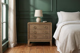 Serramanna latte elm nightstand with a ceramic lamp in a Savannah bedroom with deep green panelled walls and heart-pine floors