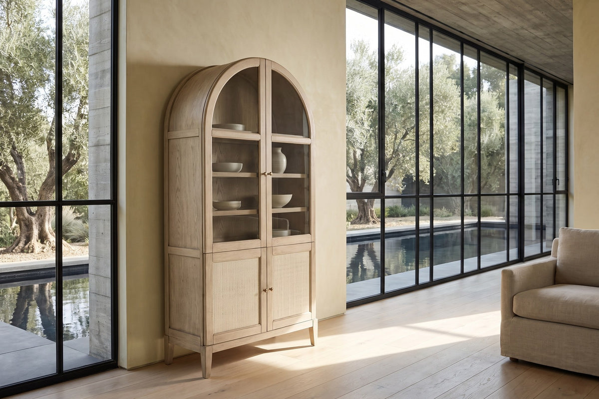 Serrastretta 42-Inch 4-Door Arched Oak Veneer Display Cabinet with Glass and Cane in a sunlit villa dining room
