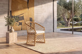 Sersale Natural Rattan Barrel-Back Dining Chair in a sunlit villa dining room