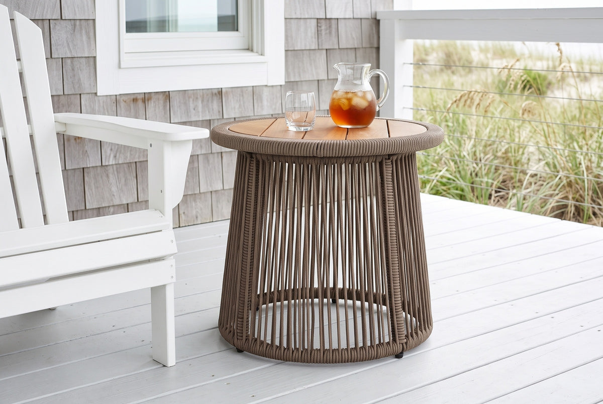 Siculiana rope side table with a pitcher of iced tea beside a white Adirondack chair on an Outer Banks beach house deck, a cedar shingle wall and dune grass beyond (chair and decor not included)