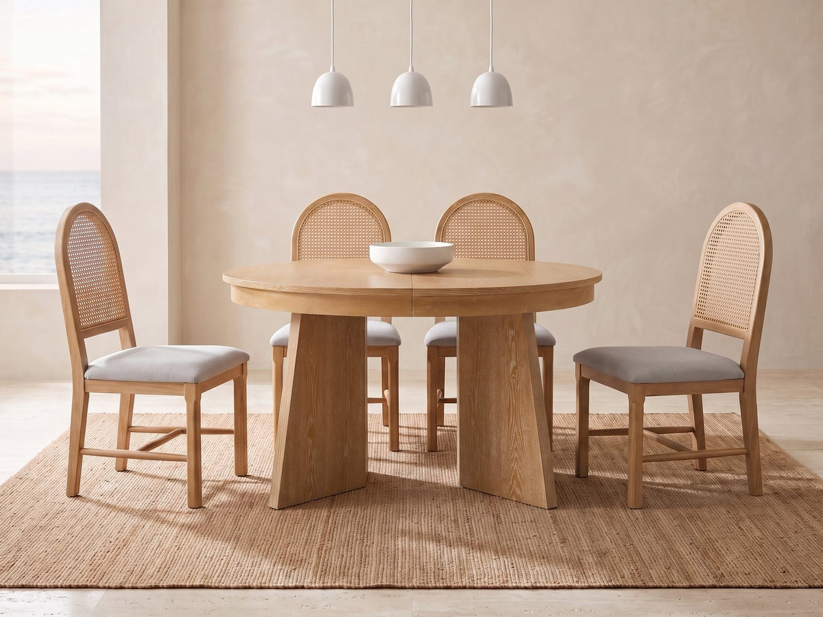 Siderno 42-Inch Extending Round Dining Set with 4 Chairs in a bright coastal dining room on a jute rug
