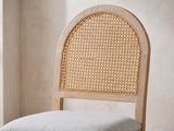 Close-up of the Siderno 42-Inch Extending Round Dining Set with 4 Chairs: the round-arched back with its woven cane-look panel and the light grey fabric seat