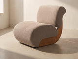 Siena Curved Slipper Chair in taupe against a plaster wall in morning light