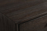 Close-up of the dark wire-brushed acacia on the Siniscola nightstand: the top edge and the frame around the drawer