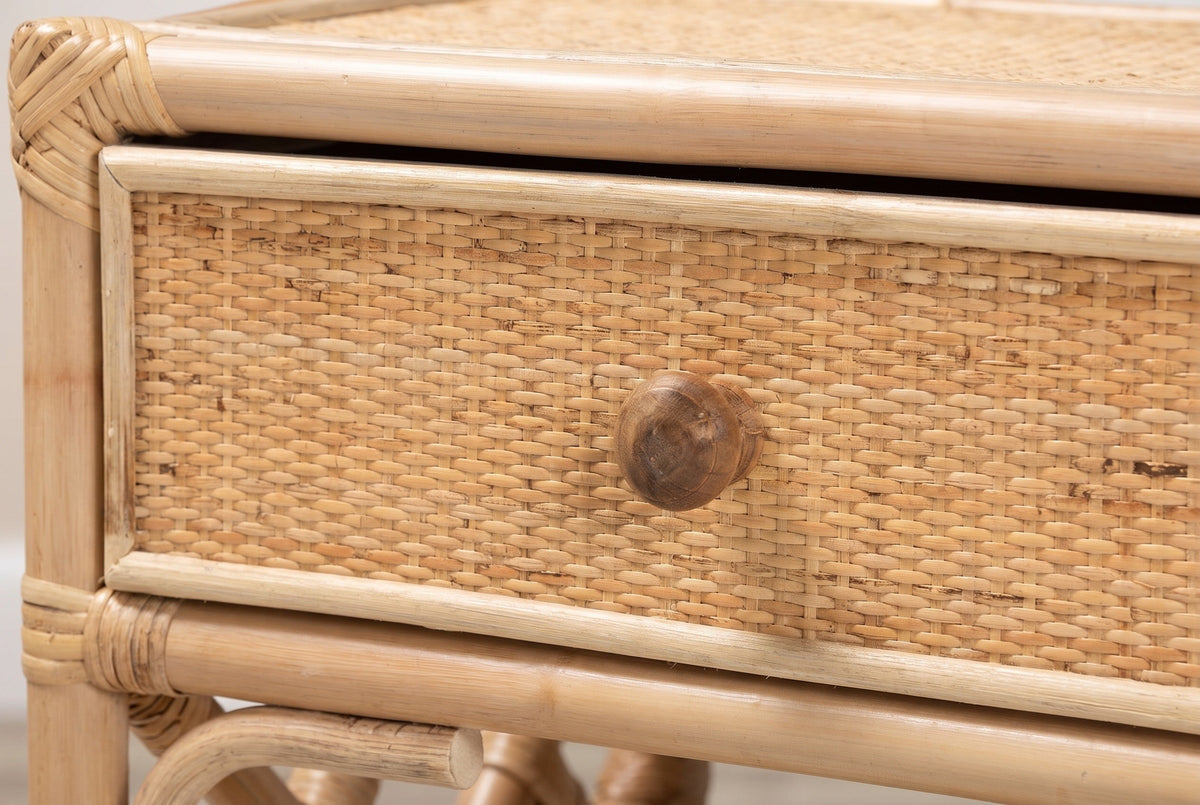 The woven rattan drawer of the Sinnai nightstand with its round dark wood knob and a diamond-wrapped corner of the top