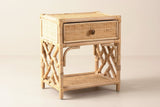 The Sinnai one-drawer nightstand in natural rattan with Chippendale lattice sides, three-quarter view on a light studio backdrop