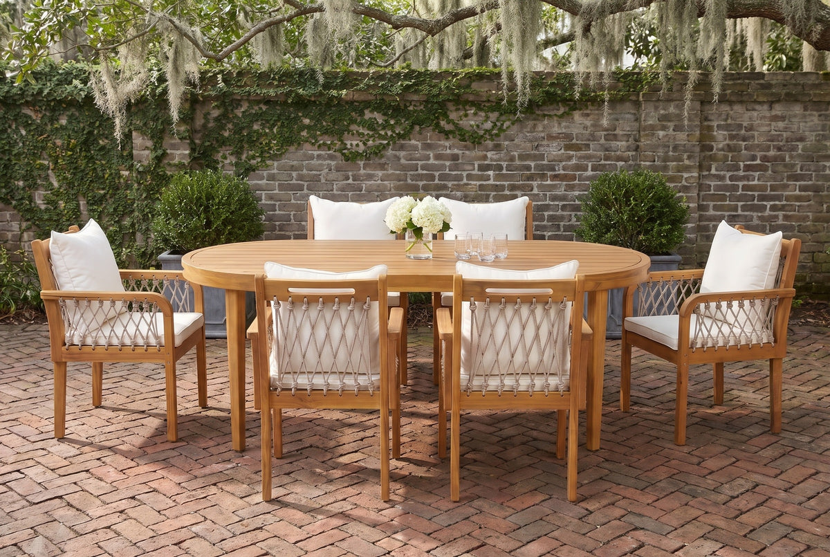 Siracusa acacia oval dining set with six rope armchairs in a Savannah courtyard garden, an old grey brick wall with creeping fig and a herringbone brick floor (tableware not included)
