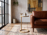 Soleto White Marble Ring-Base Side Table beside a leather sofa in an industrial loft