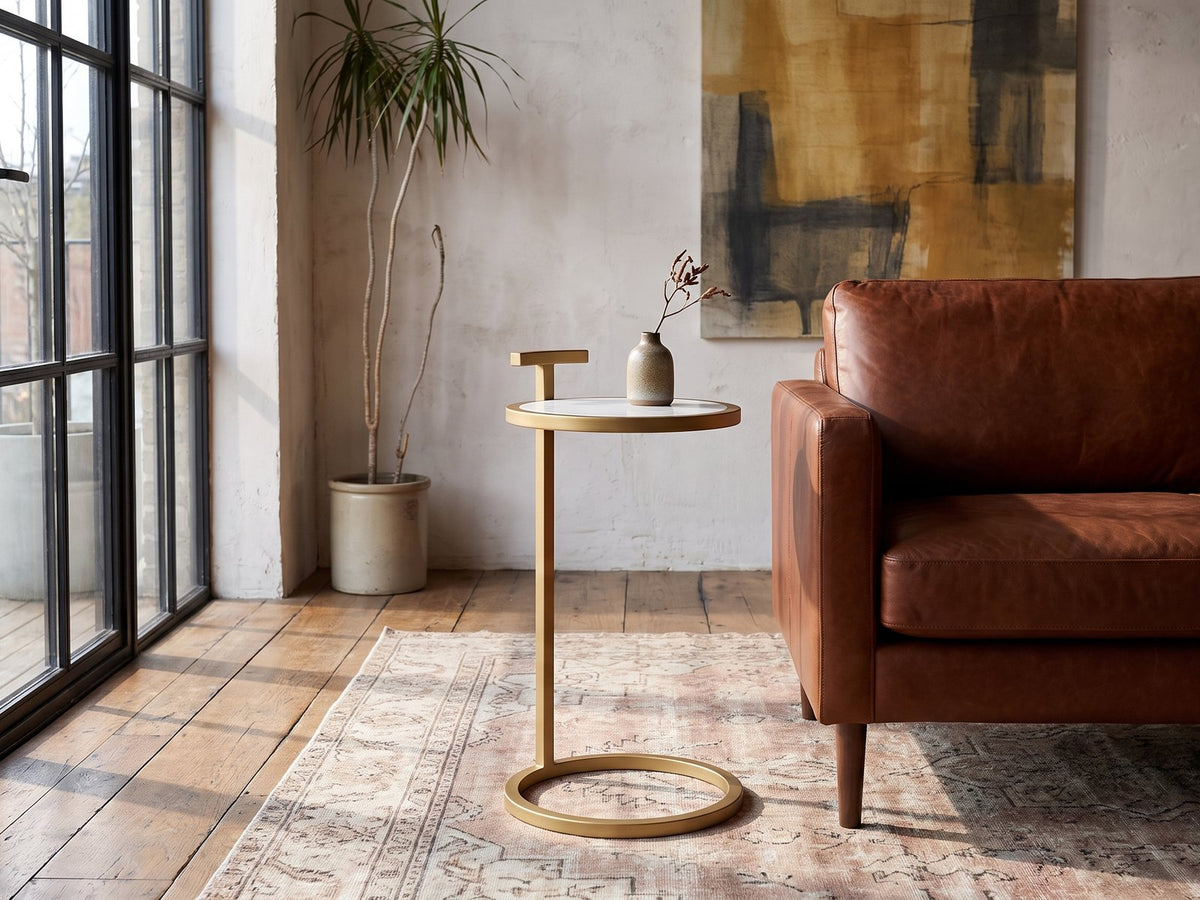 Soleto White Marble Ring-Base Side Table beside a leather sofa in an industrial loft
