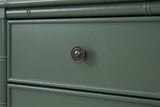 The upper drawer of the Sorgono nightstand: a round antique brass knob on a framed vintage green drawer front below a bamboo rail