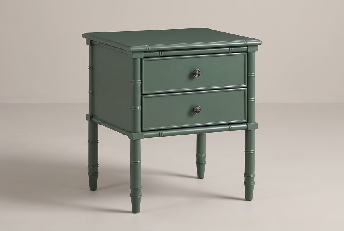 The Sorgono two-drawer nightstand in vintage green with faux-bamboo posts and legs, three-quarter view on a light studio backdrop