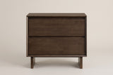 The Sorso nightstand in warm brown solid wood, front view on a light studio backdrop