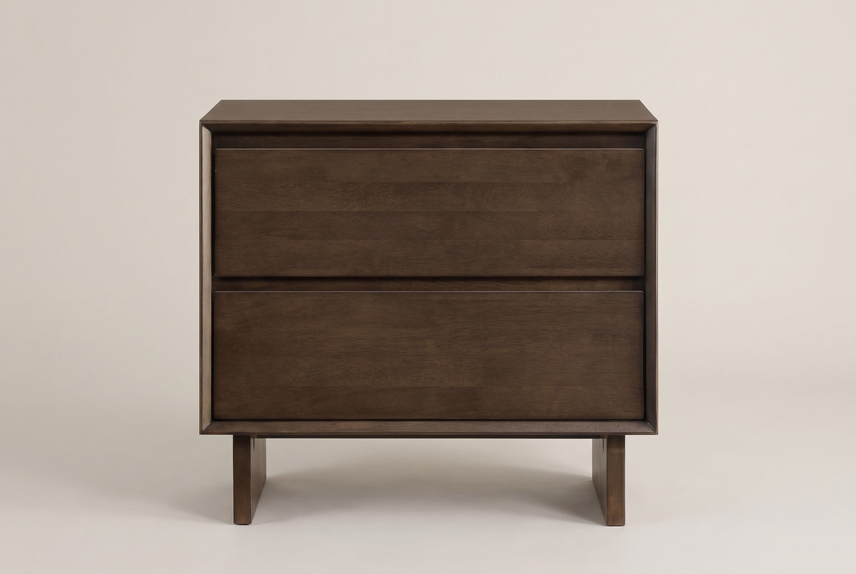 The Sorso nightstand in warm brown solid wood, front view on a light studio backdrop