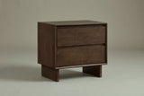 The Sorso two-drawer nightstand in warm brown solid wood, three-quarter view on a light studio backdrop