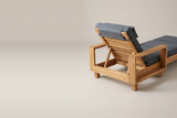 The head end of the Sortino chaise from behind: the slatted backrest raised on its prop stand between the two box arms