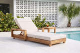 Sortino acacia chaise with a cream cushion on a terrazzo pool deck at a Sarasota mid-century house, a white breeze-block wall and a sabal palm behind (side table not included)
