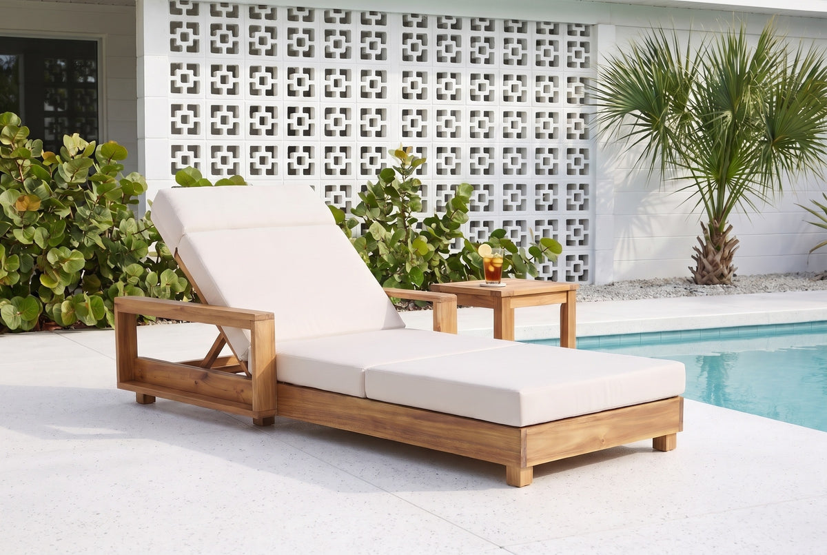 Sortino acacia chaise with a cream cushion on a terrazzo pool deck at a Sarasota mid-century house, a white breeze-block wall and a sabal palm behind (side table not included)