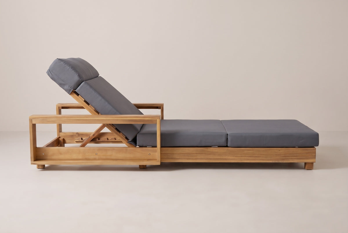 The Sortino chaise lounge seen from the side: the box arm and raised backrest on the left, the long low frame on block legs
