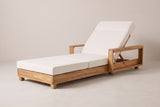 The Sortino acacia chaise lounge with a cream cushion, three-quarter view from the foot end on a light studio backdrop