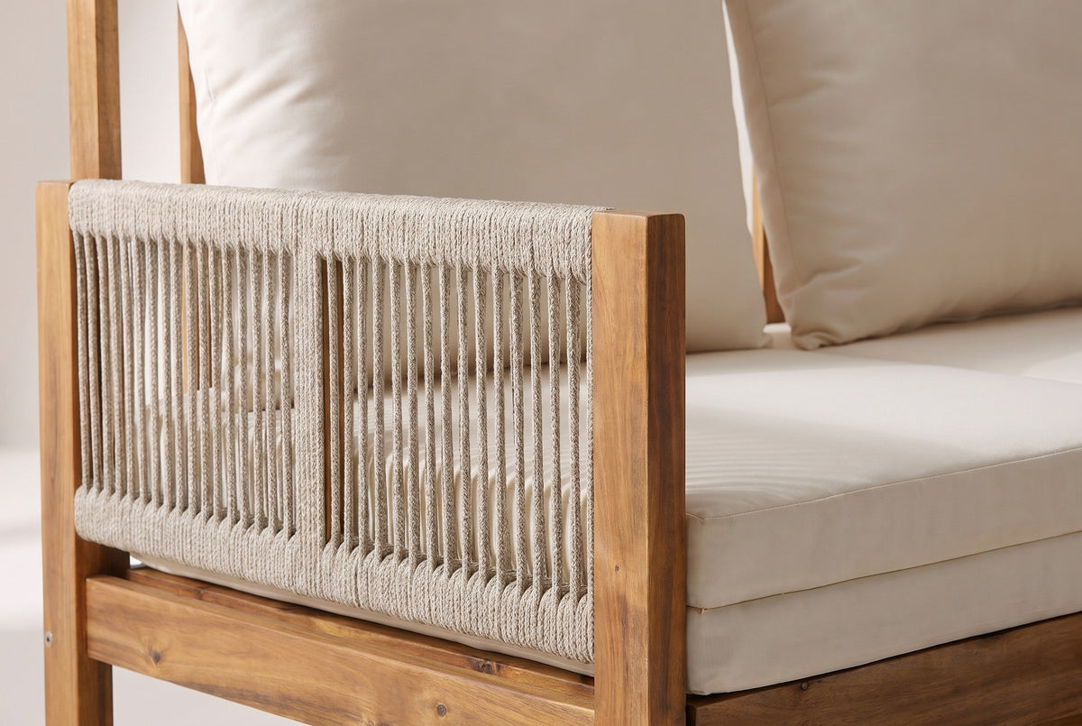 Close-up of the rope-woven arm and acacia post on the Sperlinga sofa, beside the stacked seat pads