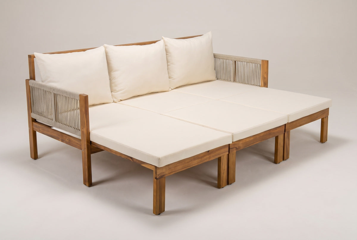 The Sperlinga in daybed mode: all three extensions pulled out, six ivory-beige pads in a 3 by 2 grid, three back cushions and rope arms