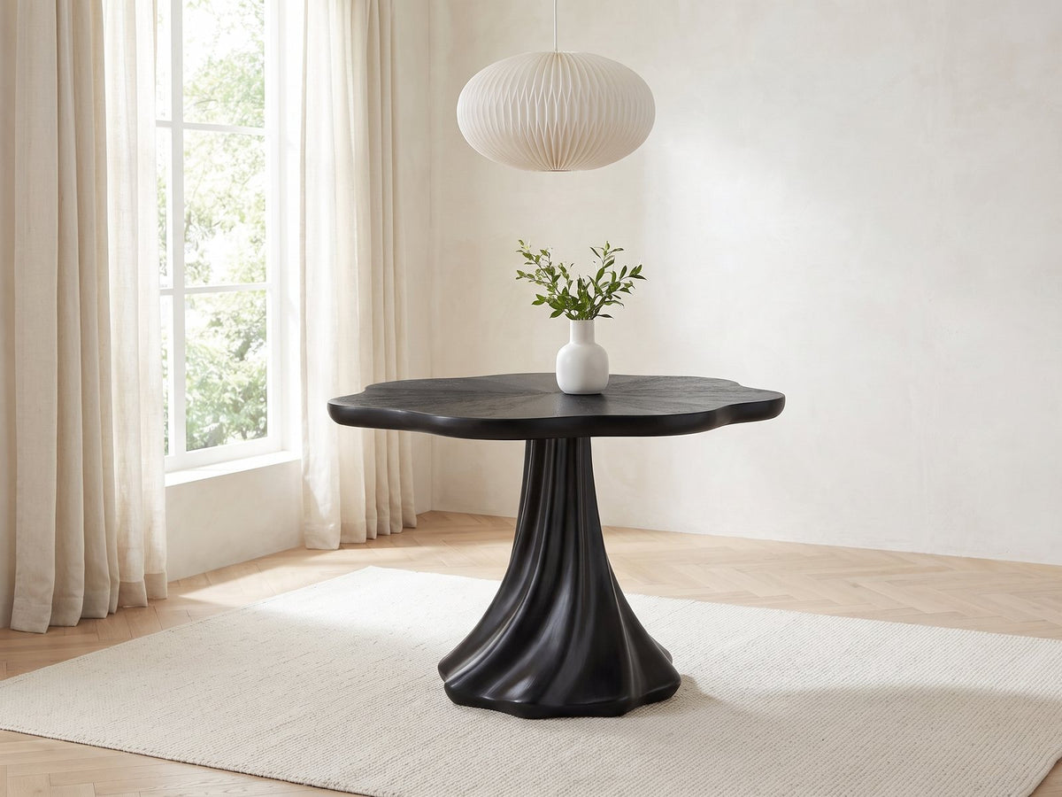 Spilimbergo Black Fiberglass Twisted Petal Pedestal Dining Table in a bright plaster dining room with linen curtains