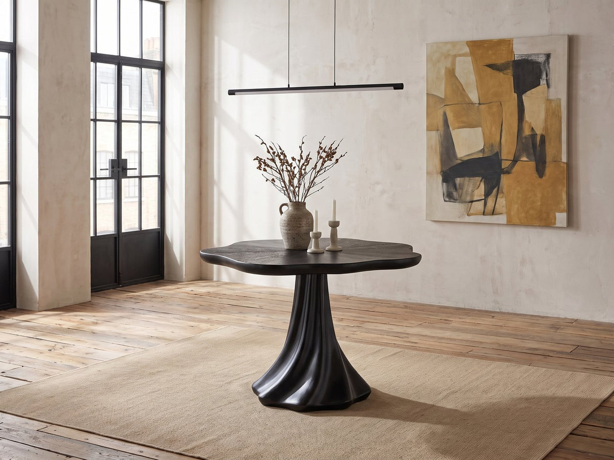 Spilimbergo Black Fiberglass Twisted Petal Pedestal Dining Table in an industrial loft dining area