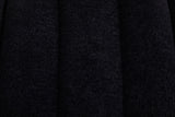 Close-up of the black chenille on the Spoleto bench: a nubby soft pile across rounded channels with a deep seam between them