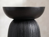 Close-up of the Stigliano Black Mango Bell Pedestal Side Table: the smooth bowl top resting on the grooved pedestal