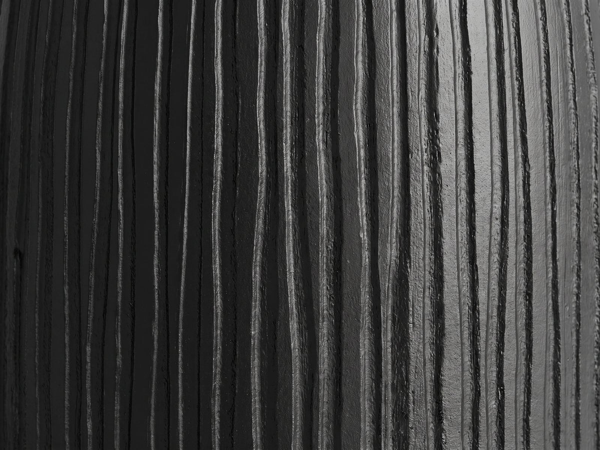 Close-up of the Stigliano Black Mango Bell Pedestal Side Table: the carved grooves of the black mango pedestal