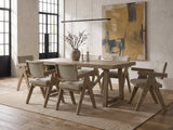 Stilo 84-Inch Weathered Oak Trestle Dining Set with 6 Armchairs in an industrial loft dining area