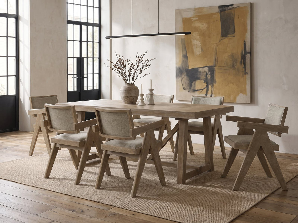Stilo 84-Inch Weathered Oak Trestle Dining Set with 6 Armchairs in an industrial loft dining area