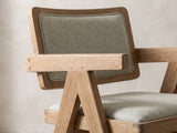 Close-up of the Stilo 84-Inch Weathered Oak Trestle Dining Set with 6 Armchairs: a Jeanneret-style armchair with plank arms and compass legs in weathered oak