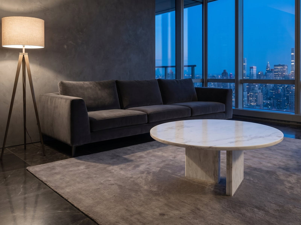 Stintino White Marble Coffee Table on a wool rug in front of a velvet sofa in a city penthouse at blue hour