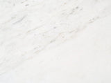 Close-up of the Stintino White Marble Coffee Table: the veining of the polished white marble top