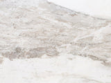 Close-up of the Stintino White Marble Round Side Table: the veining of the semi-polished white marble top
