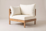 One Stromboli corner sofa on its own: a low slatted acacia frame with an end panel, a large back cushion, a side pillow and a thick ivory seat cushion