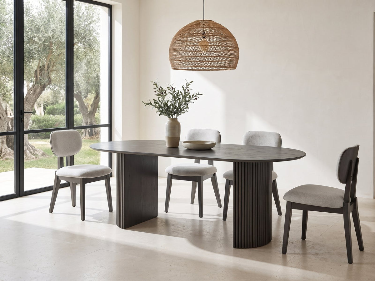 Strongoli 80-Inch Oval Fluted Pedestal Dining Set with 4 Chairs in a sunlit villa dining area with olive trees outside