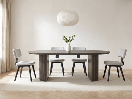 Strongoli 80-Inch Oval Fluted Pedestal Dining Set with 4 Chairs in a bright plaster dining room with linen curtains