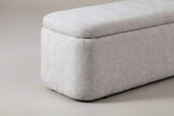 One end of the Subiaco bench: the plump pillow-top lid and the rounded corner of the box curving down to the floor