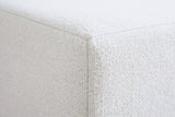 Close-up of the ivory textured canvas on the Sulmona bed where a flat rail face meets its corner along a plain seam