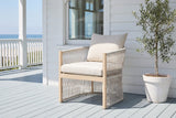 The Sutera rope lounge chair on a blue-grey painted porch in front of white clapboard in Coronado, the Pacific beyond the rail